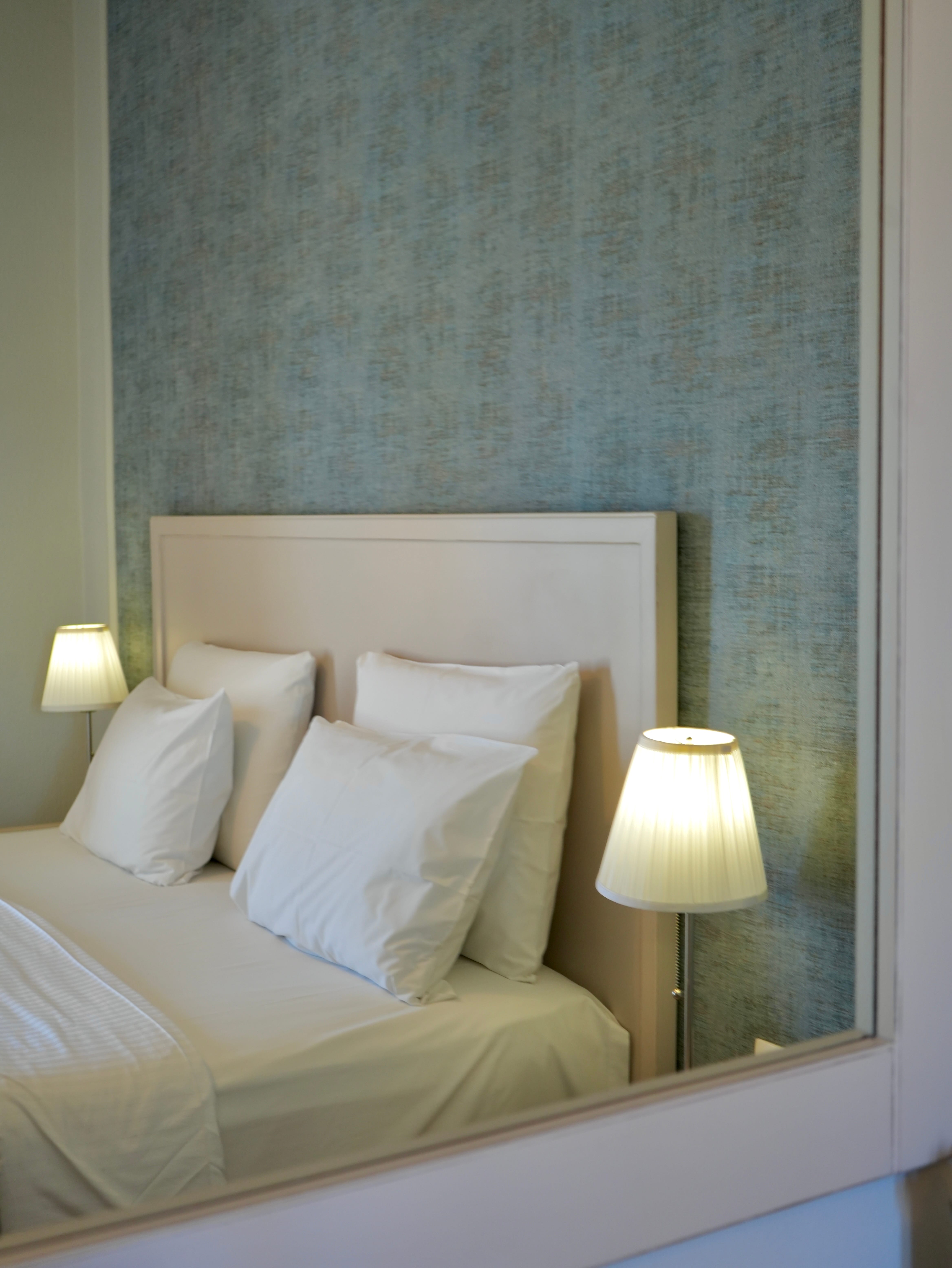 a bed with lamps on the side