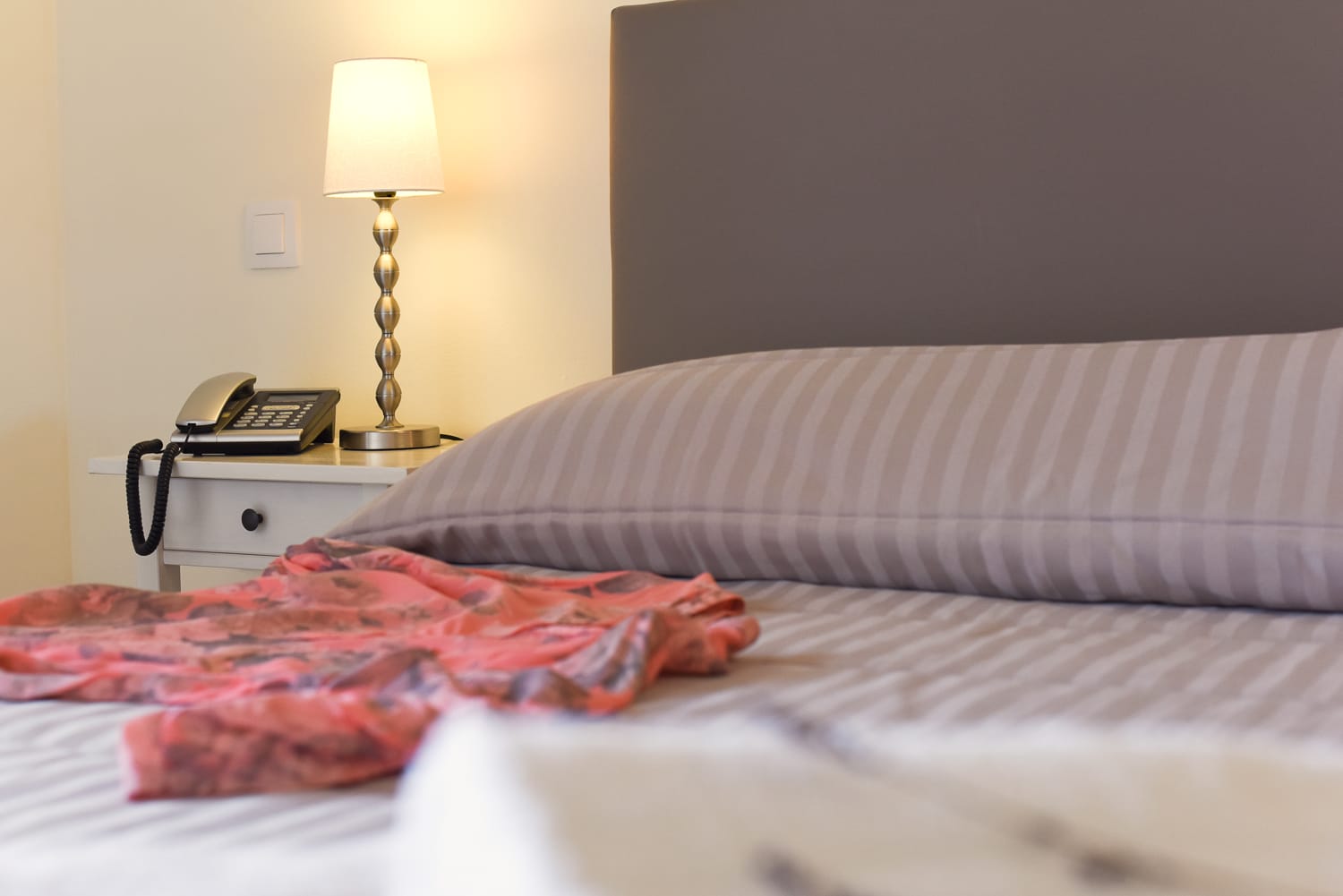 a bed with a lamp on it