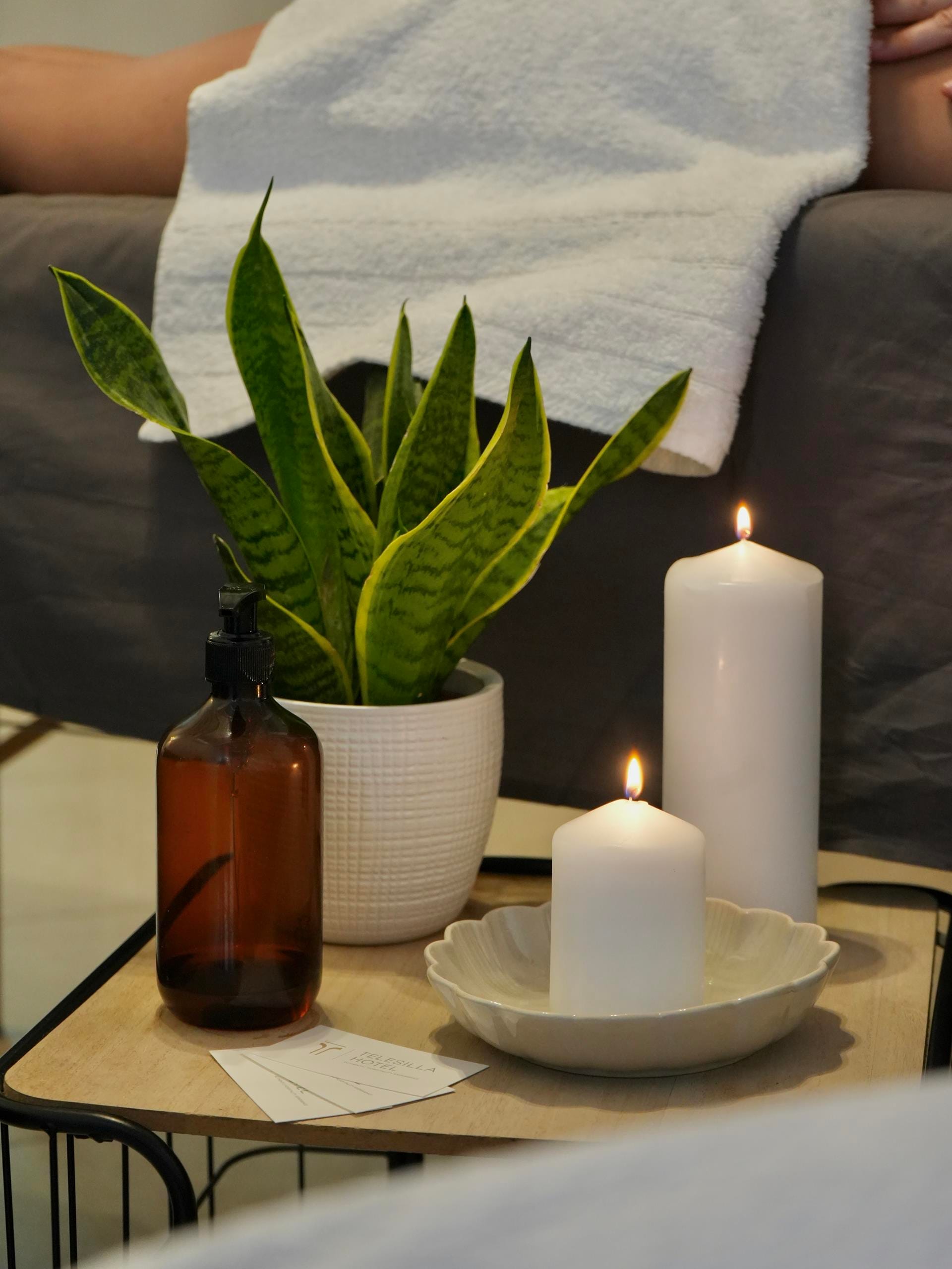 a table with candles and a plant
