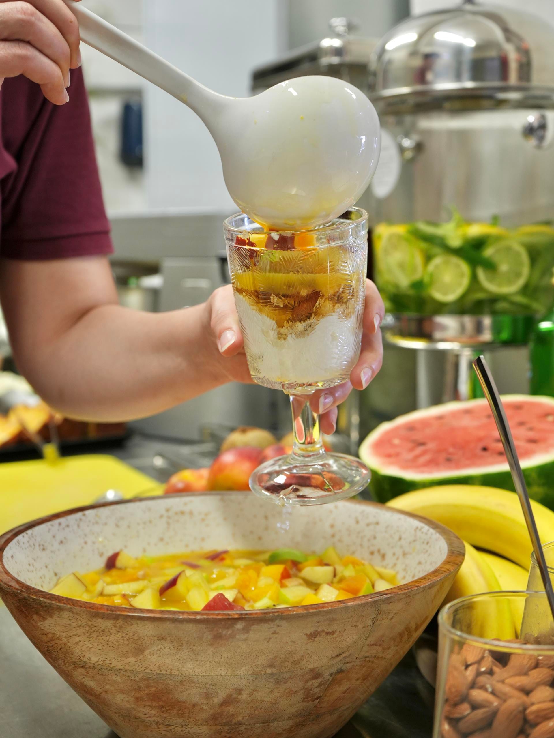 a person pouring a drink into a glass