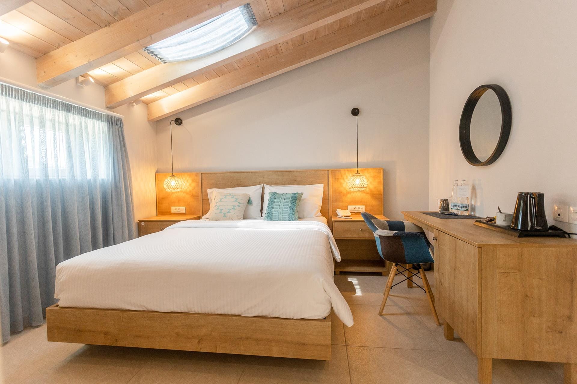 a bedroom with a bed desk and a mirror