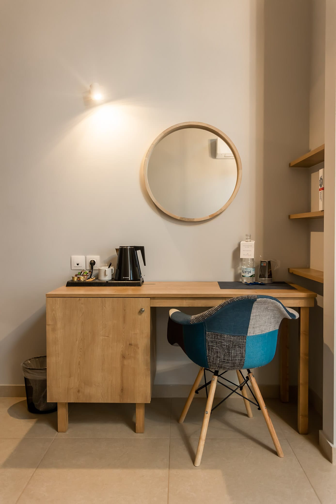 a desk with a chair and a mirror on it