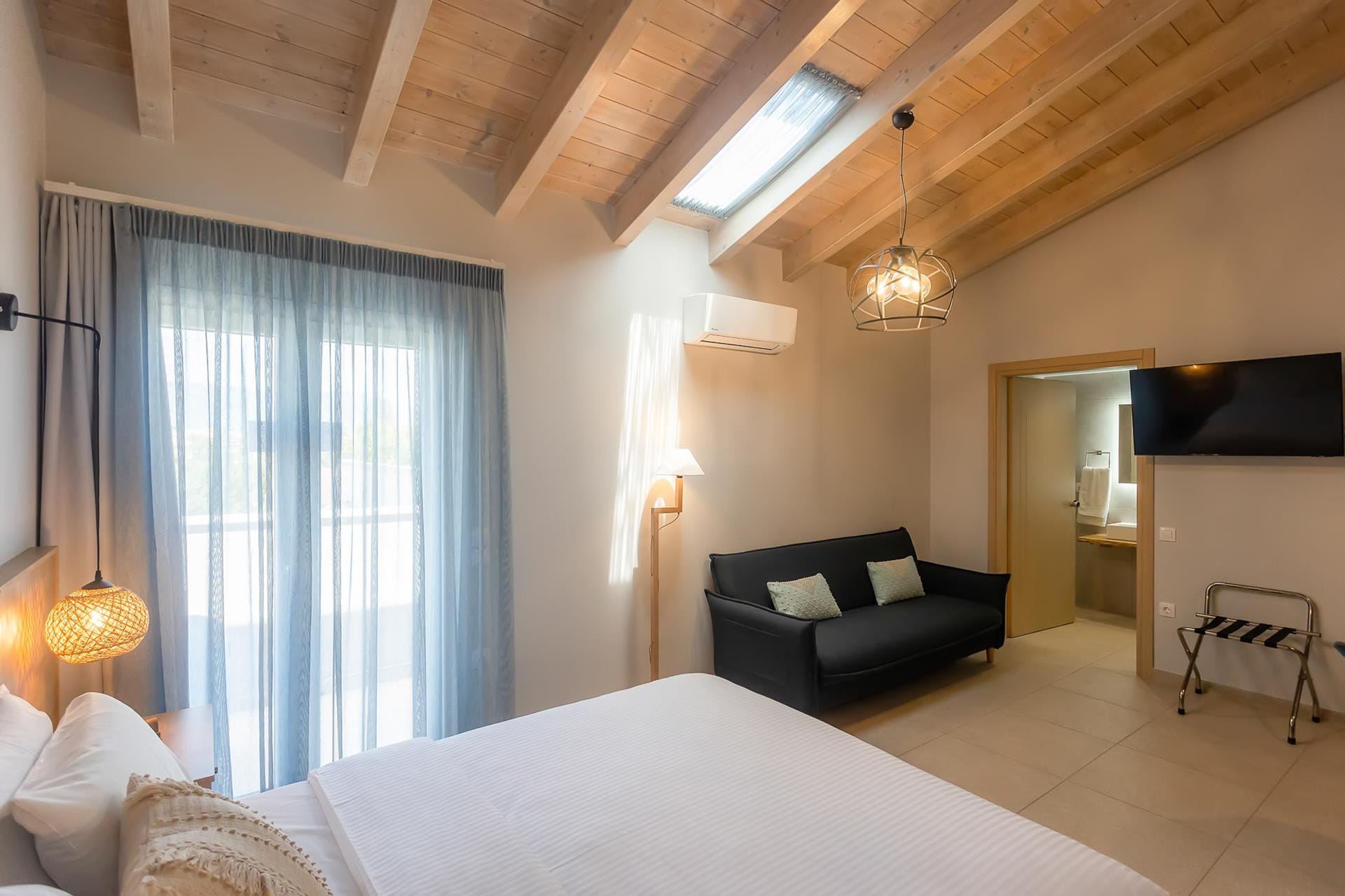 a bedroom with a bed and a couch