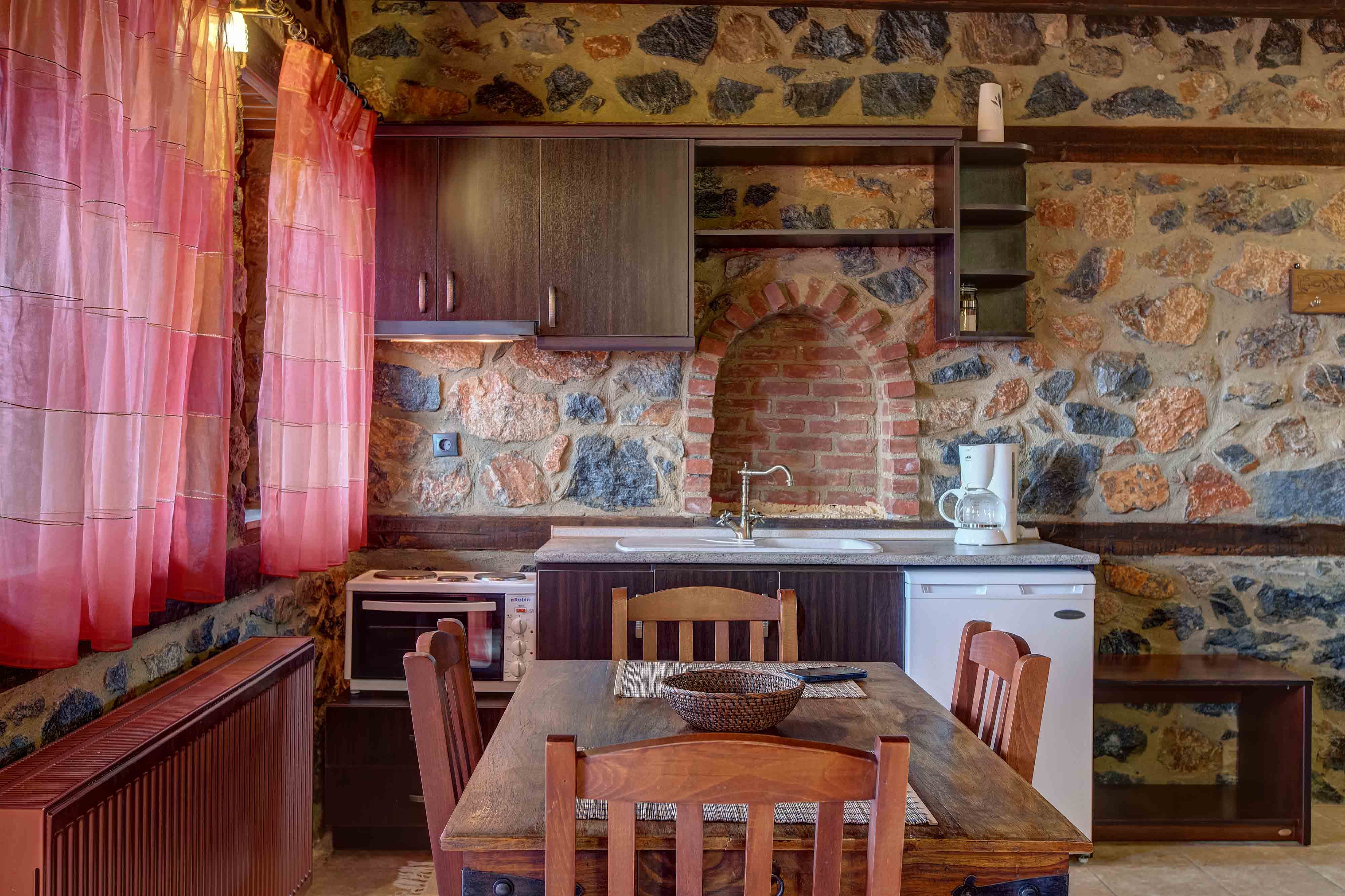 a kitchen with a table and chairs