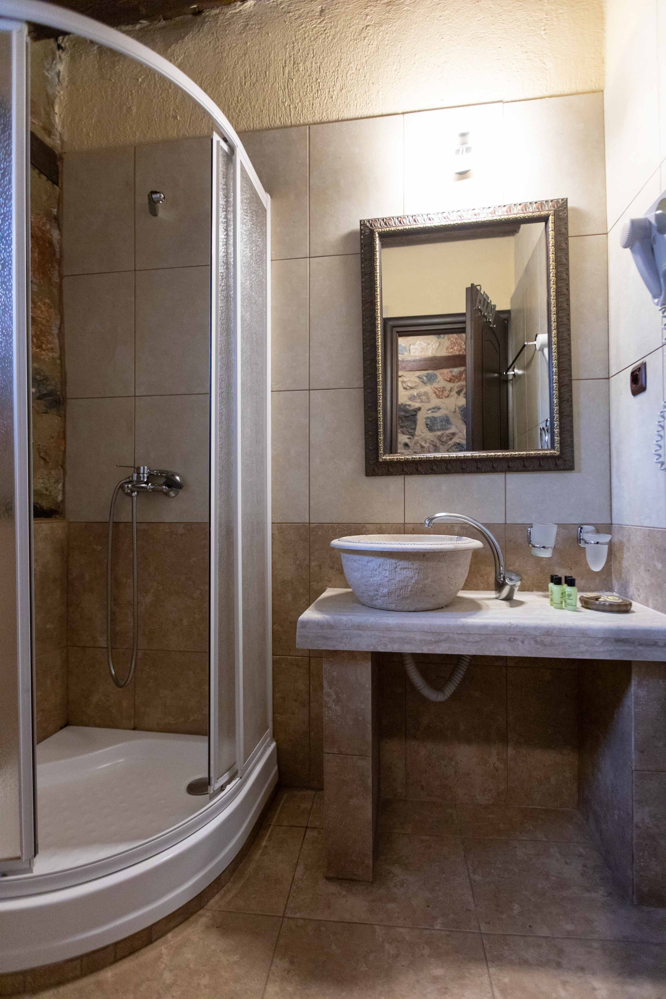 a bathroom with a sink and a shower unit