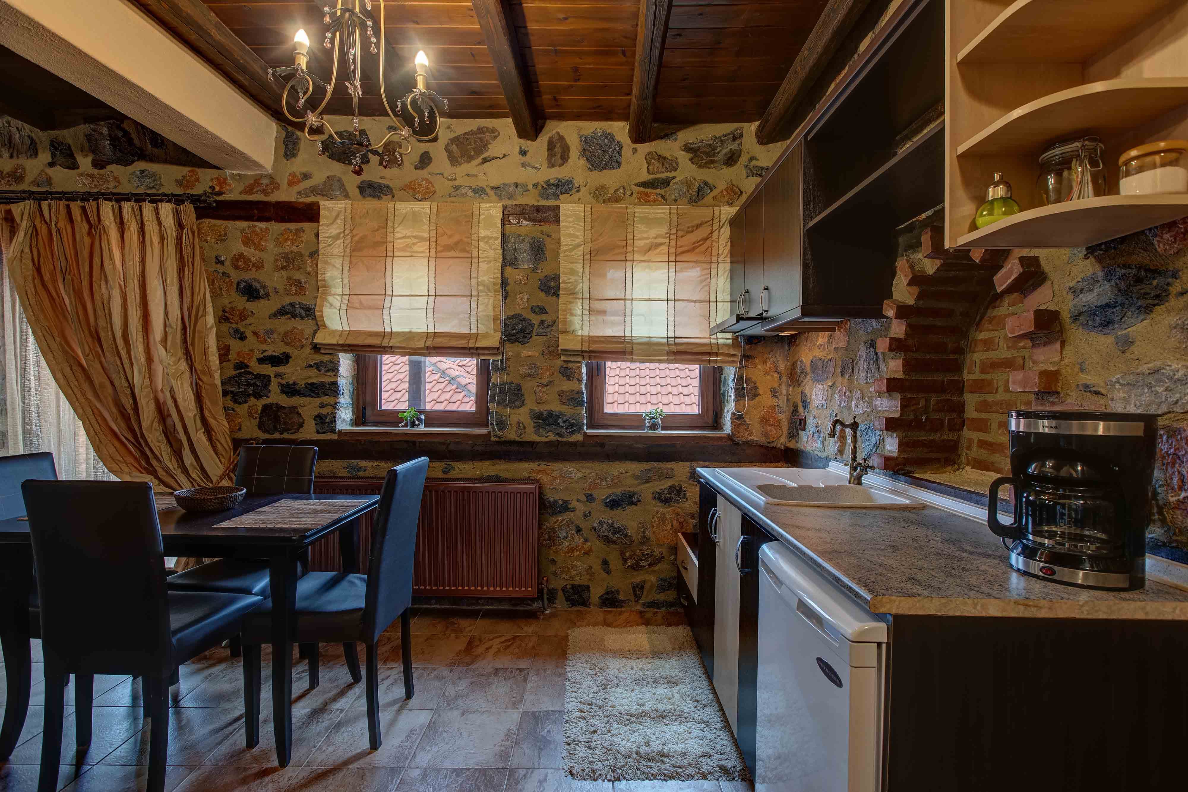 a kitchen with a bar and chairs