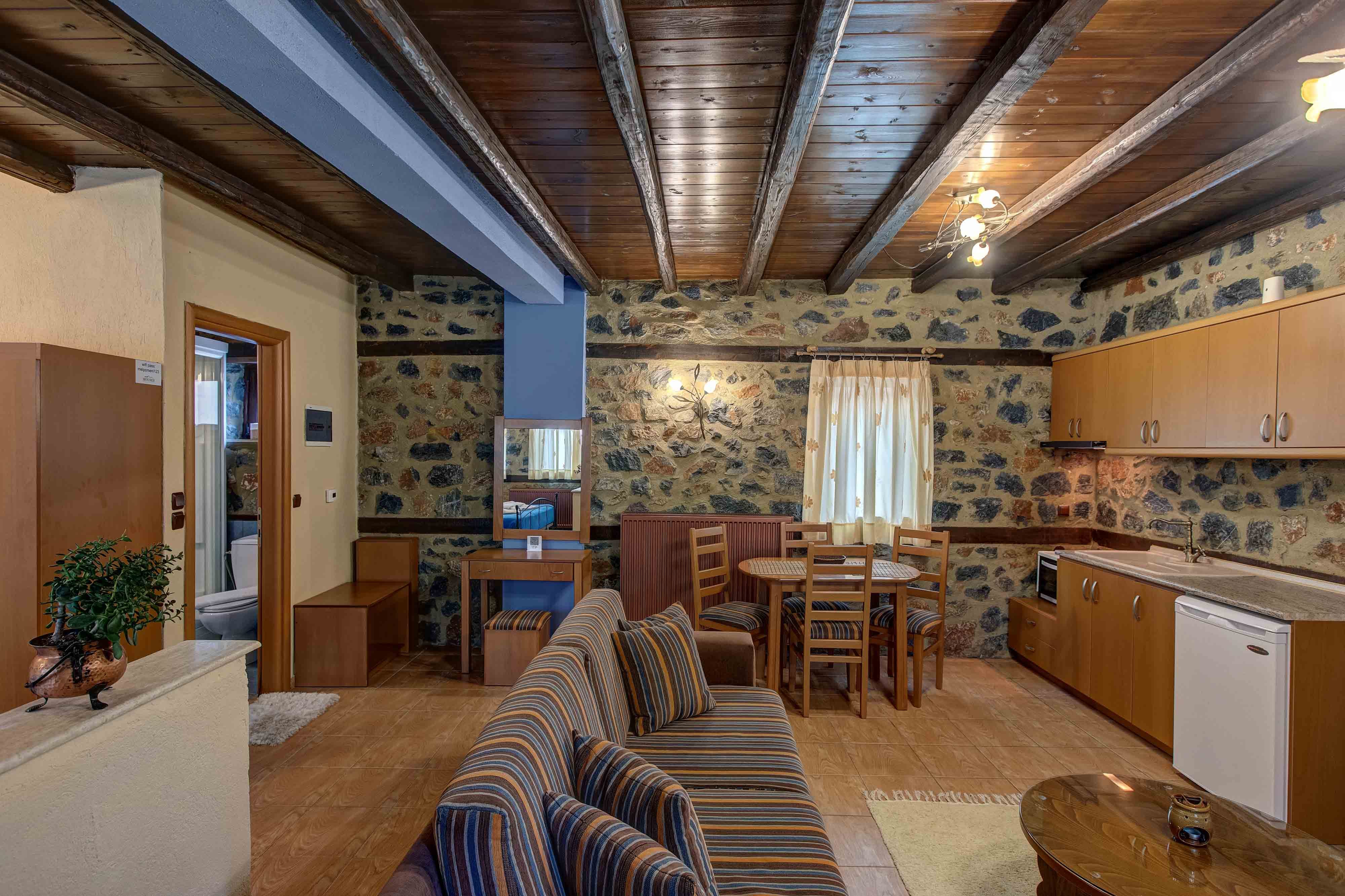 a room with a couch and chairs