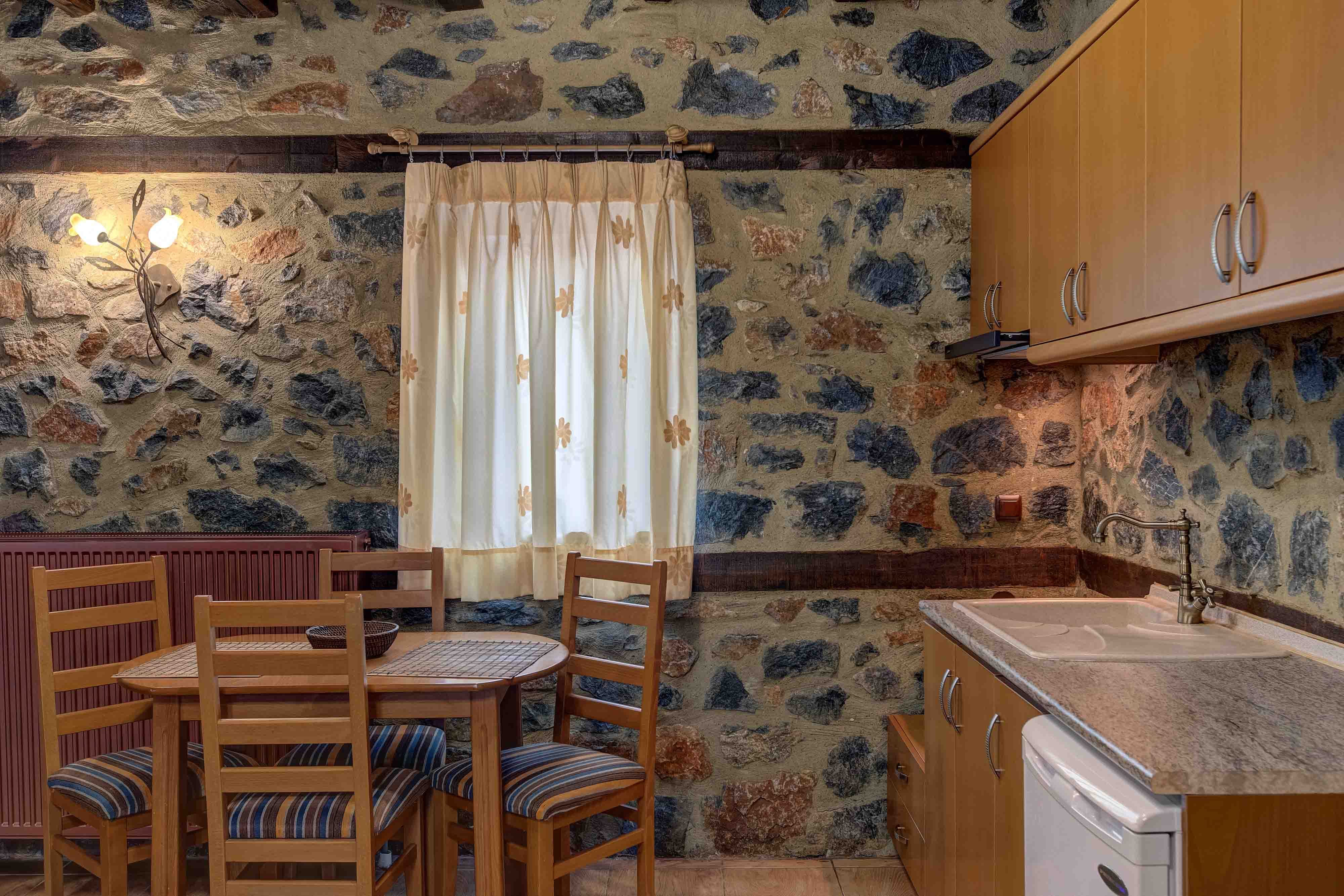 a kitchen with a table and chairs