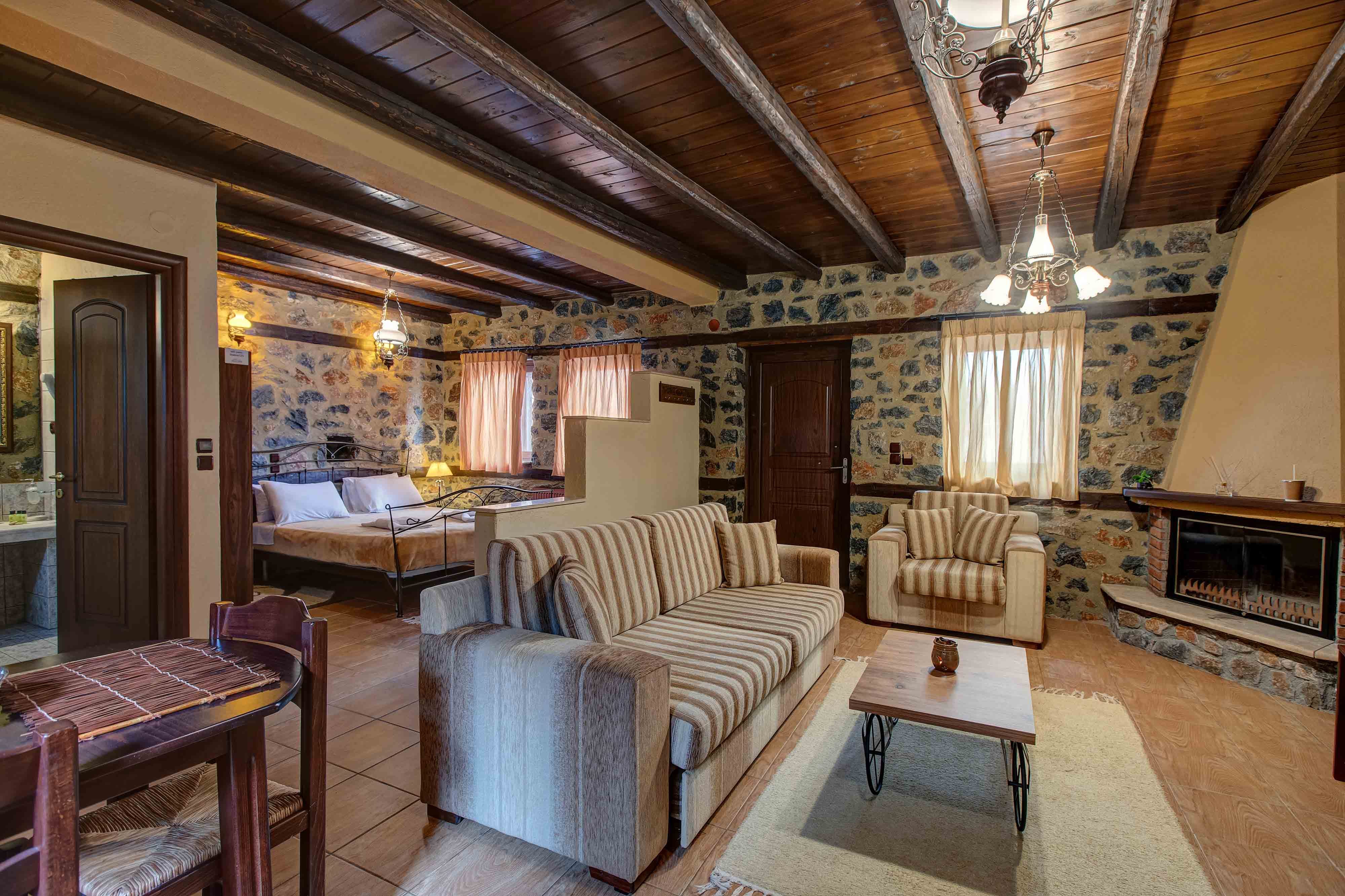 a room with a bed and chairs