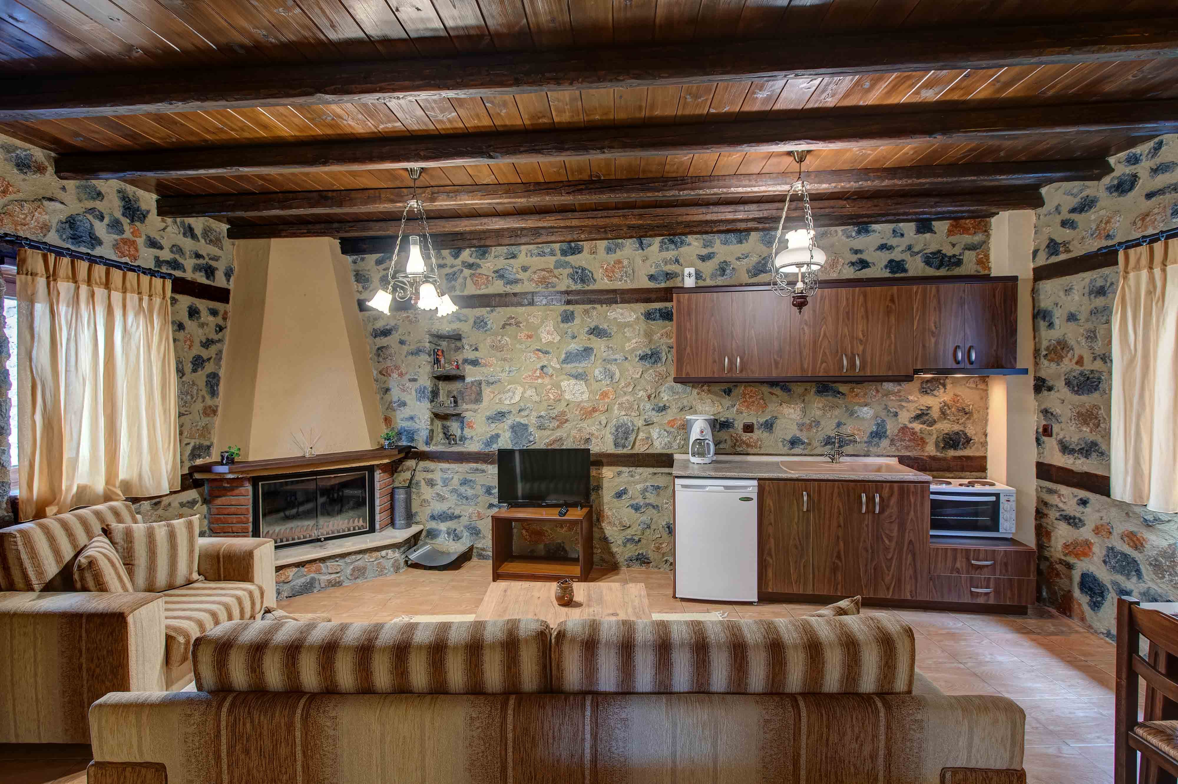 a kitchen with a fireplace and a couch