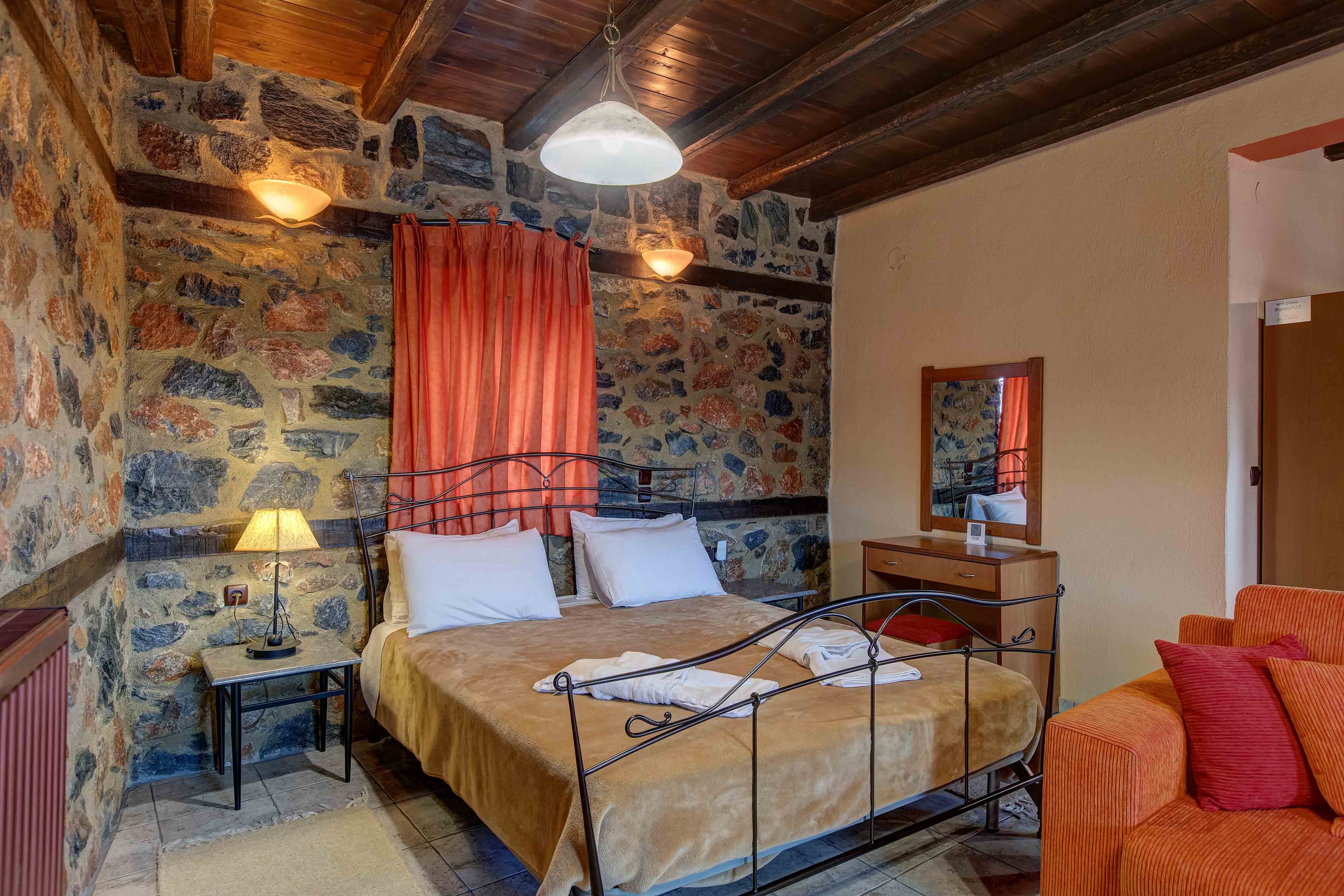 a bedroom with a bed and a couch