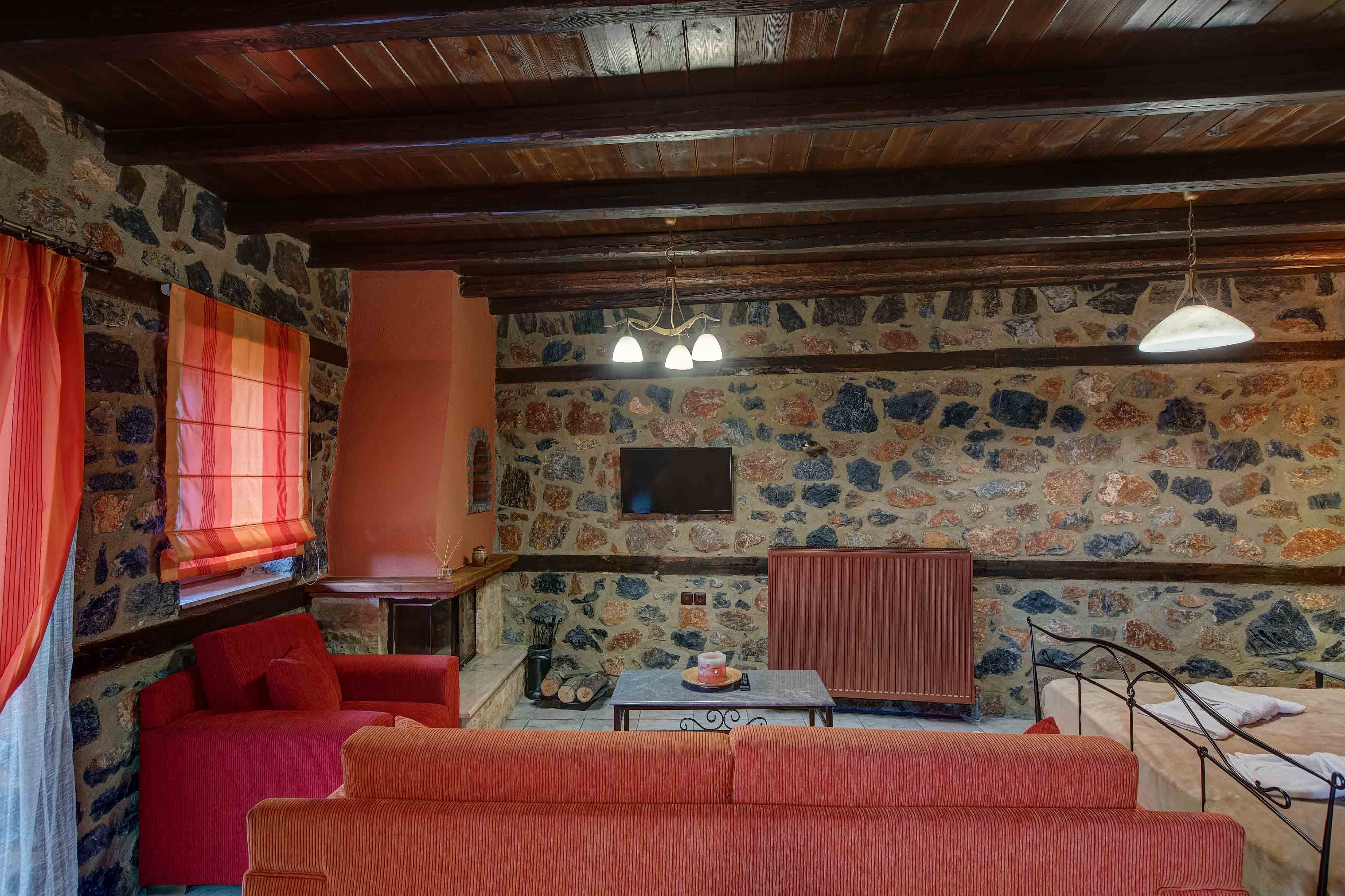 a room with red couches and a table