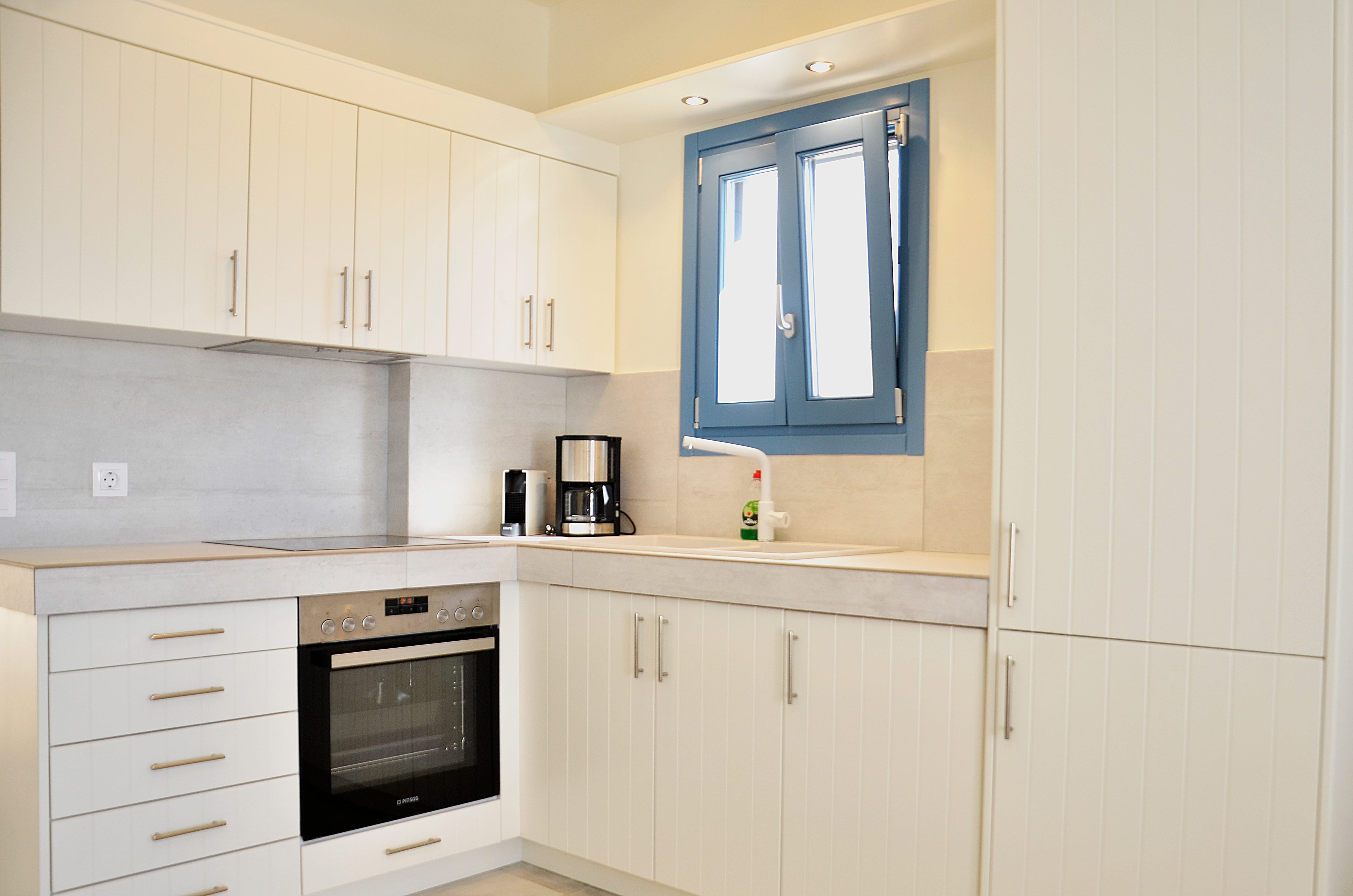 a kitchen with white cabinets