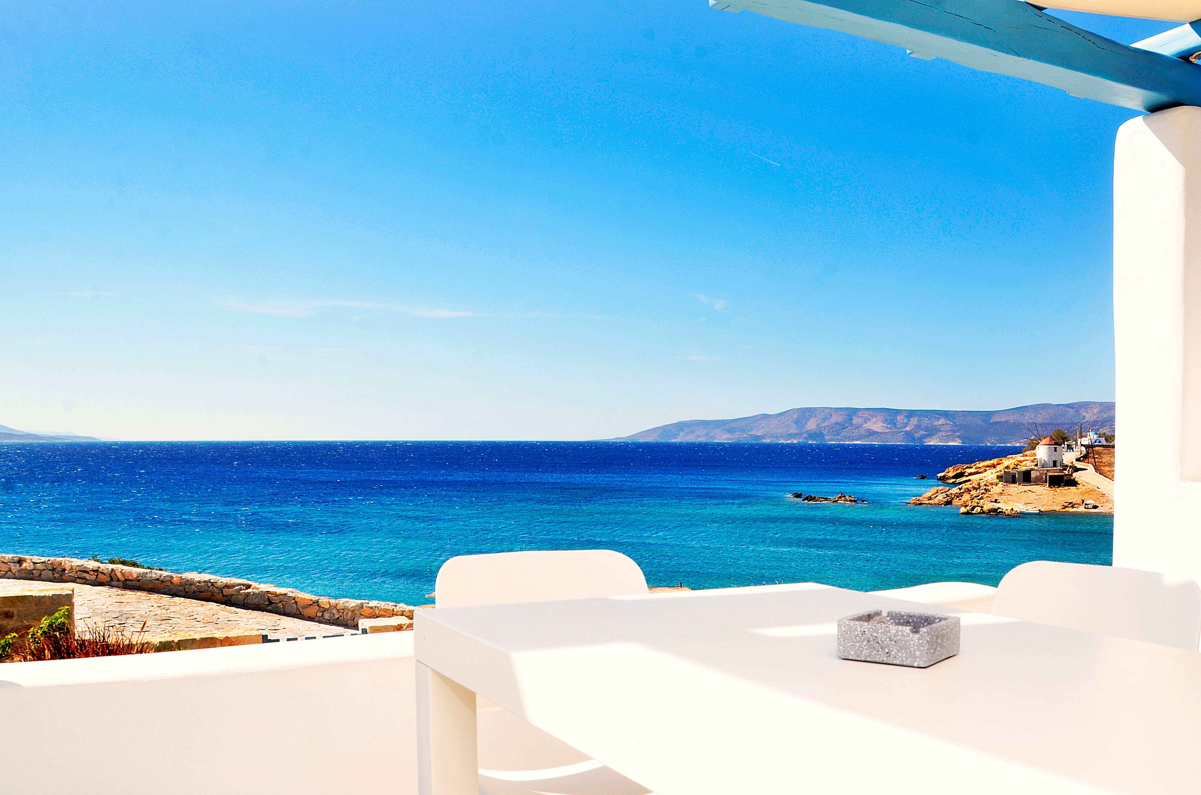 a white balcony overlooking a body of water