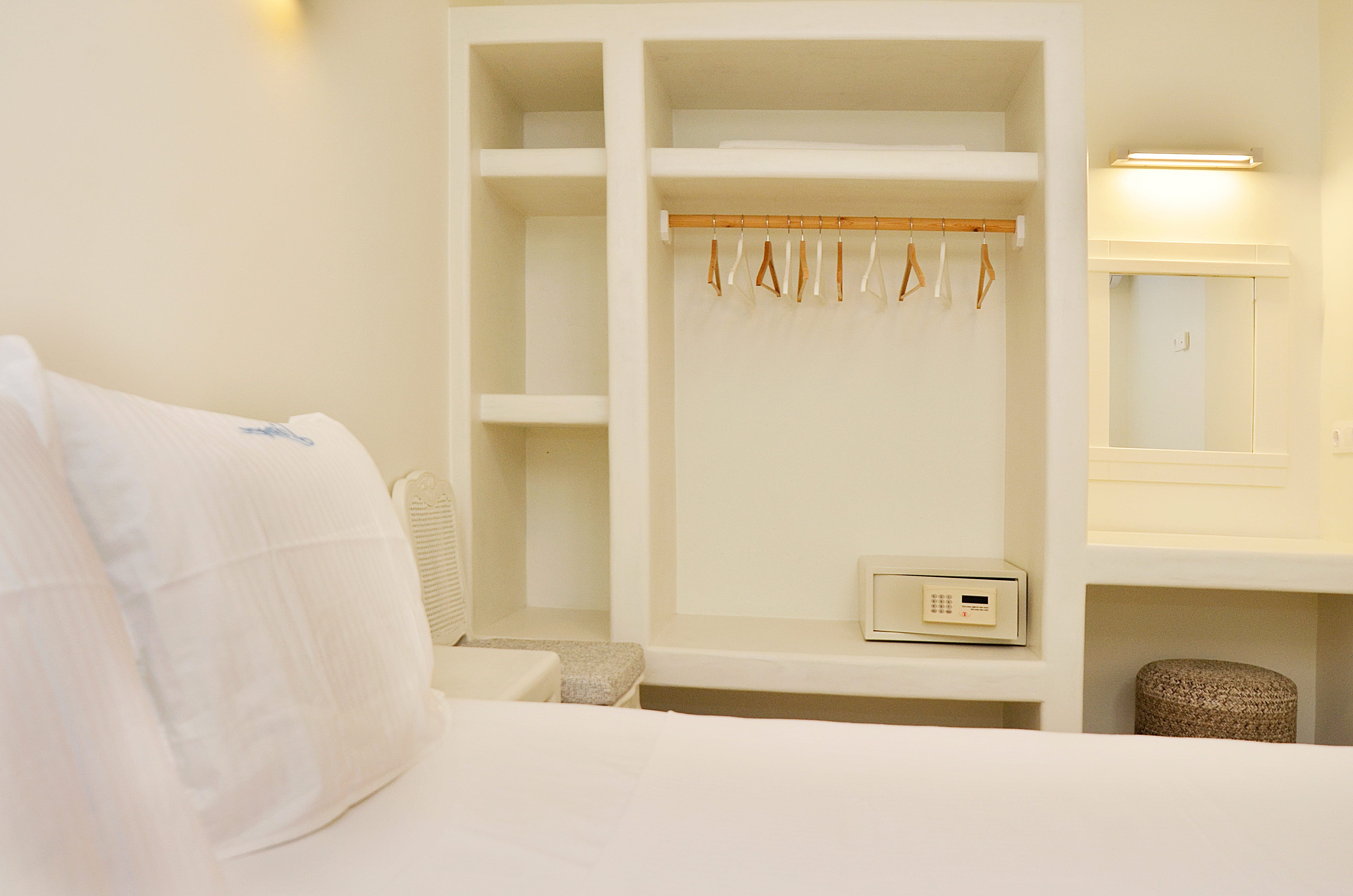 a white bed with a white pillow
