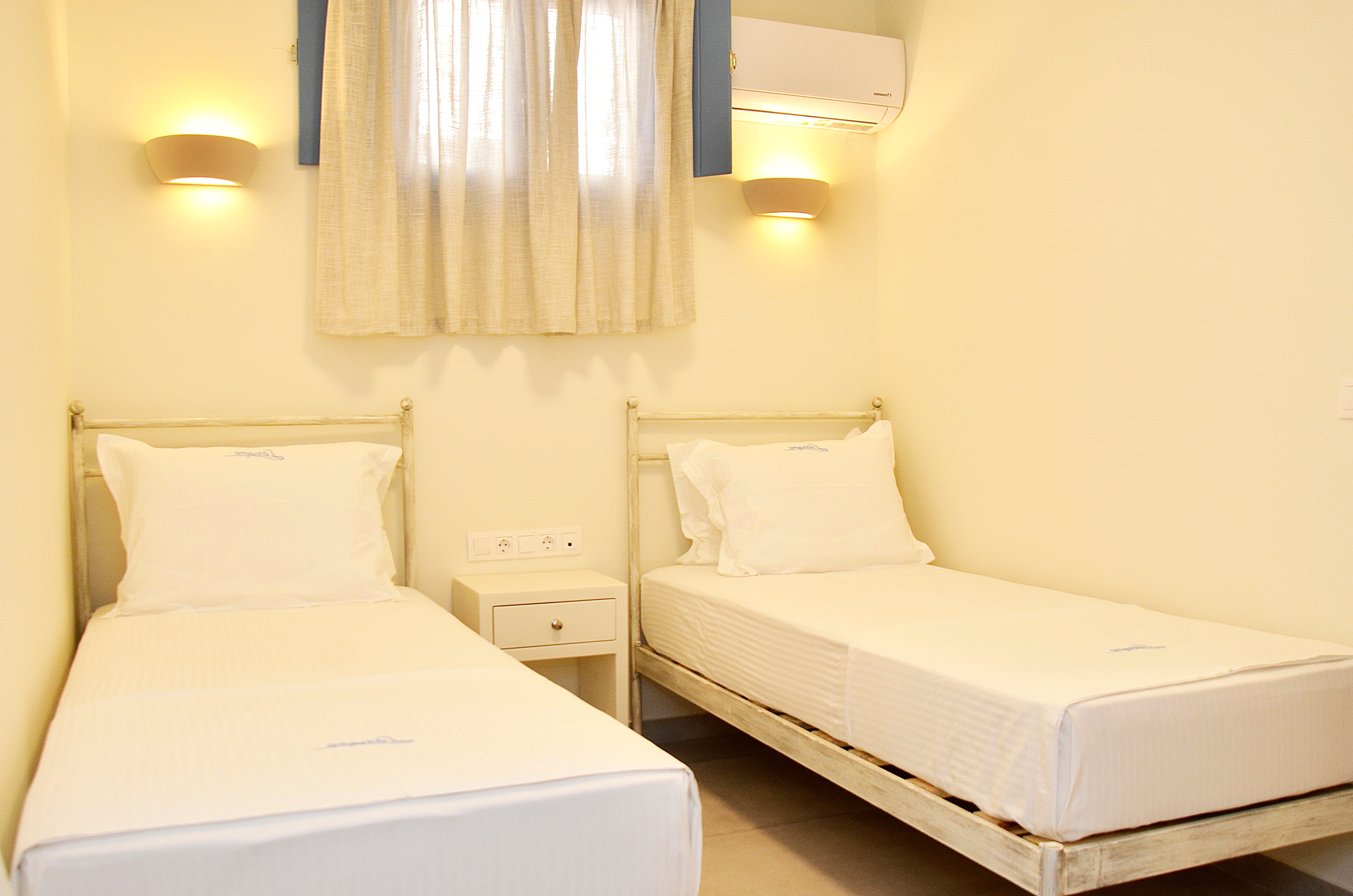 a room with white beds