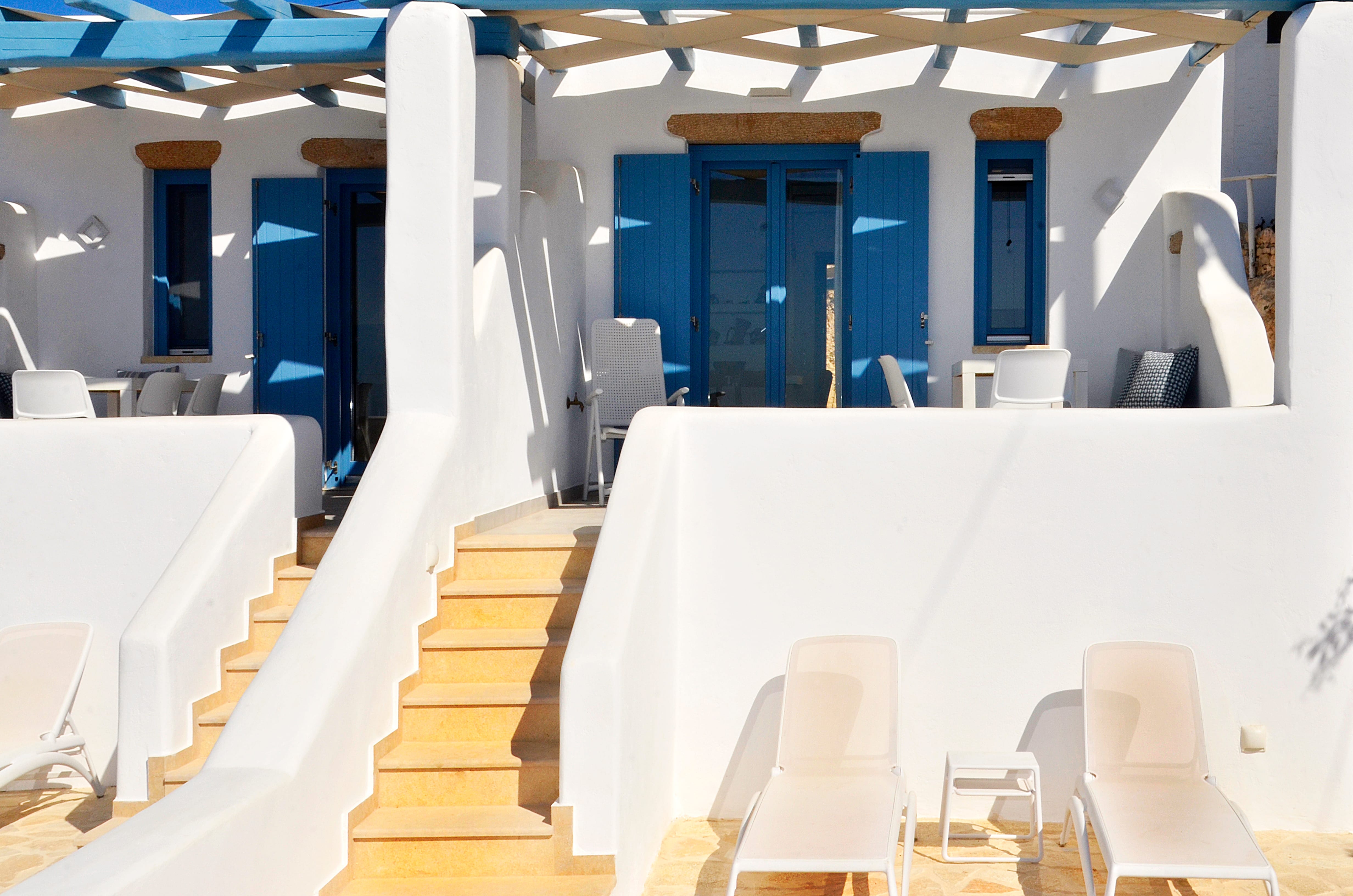 a room with white chairs and tables