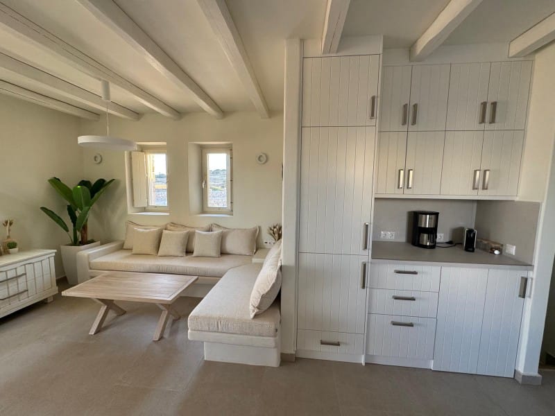 a living room with white furniture