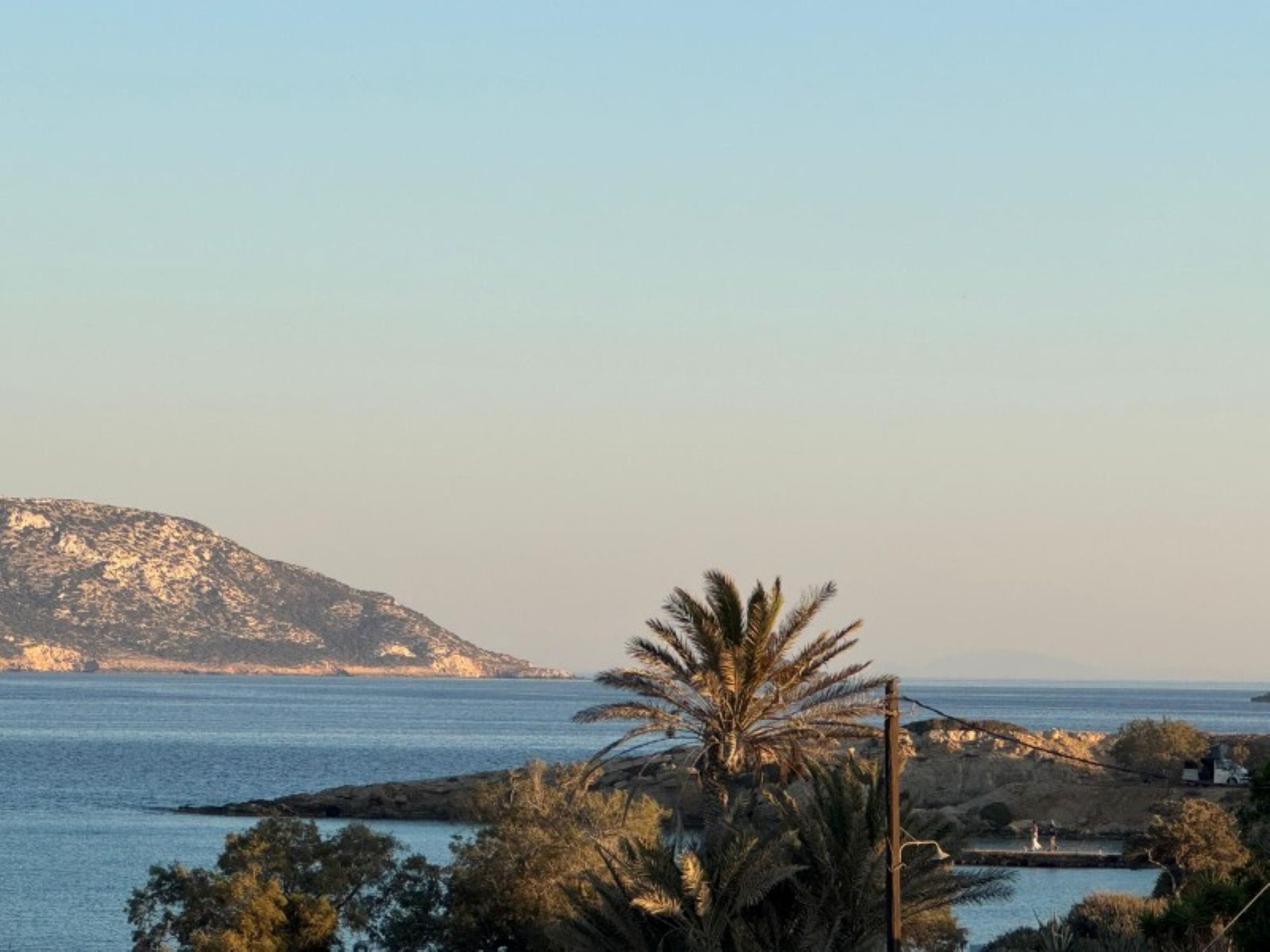 a tropical island with a body of water in the background