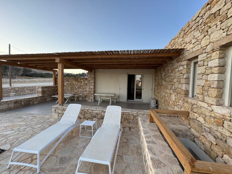 a patio with chairs and tables