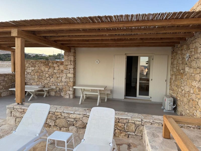 a patio with chairs and a table