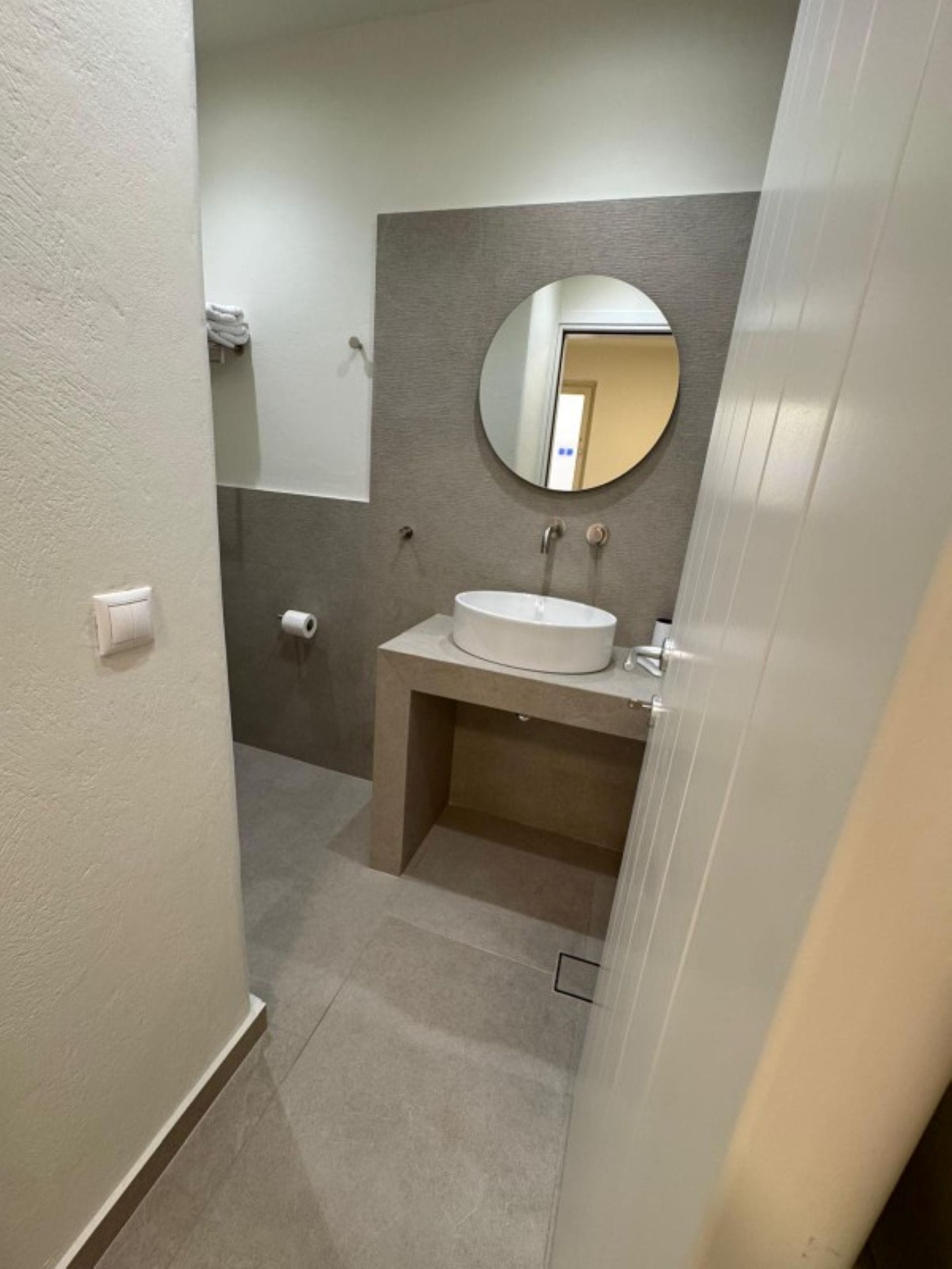 a bathroom with a round mirror