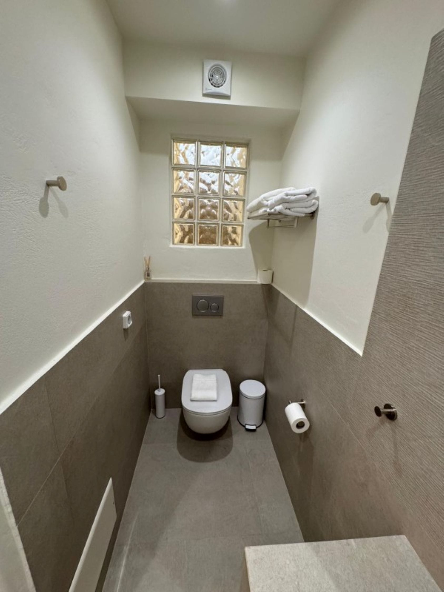 a bathroom with a toilet and a window