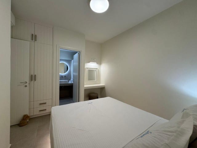 a room with a bed and a mirror