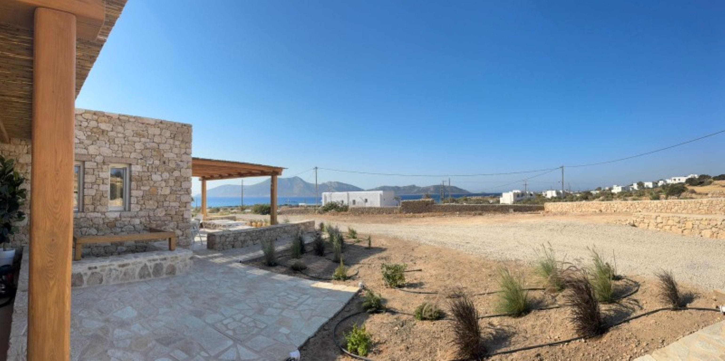 a building with a road and a field in the background