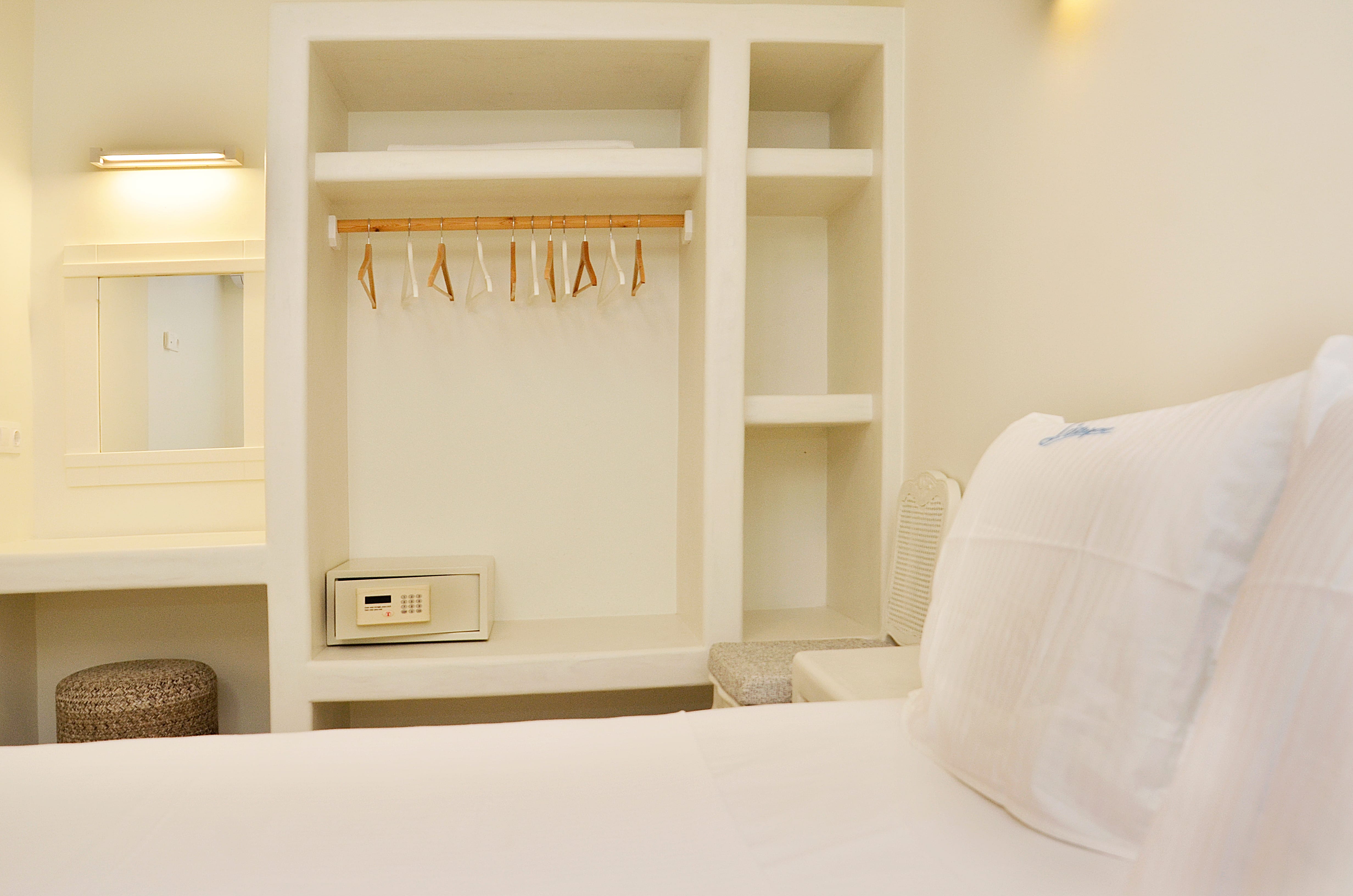 a white bed with a white pillow