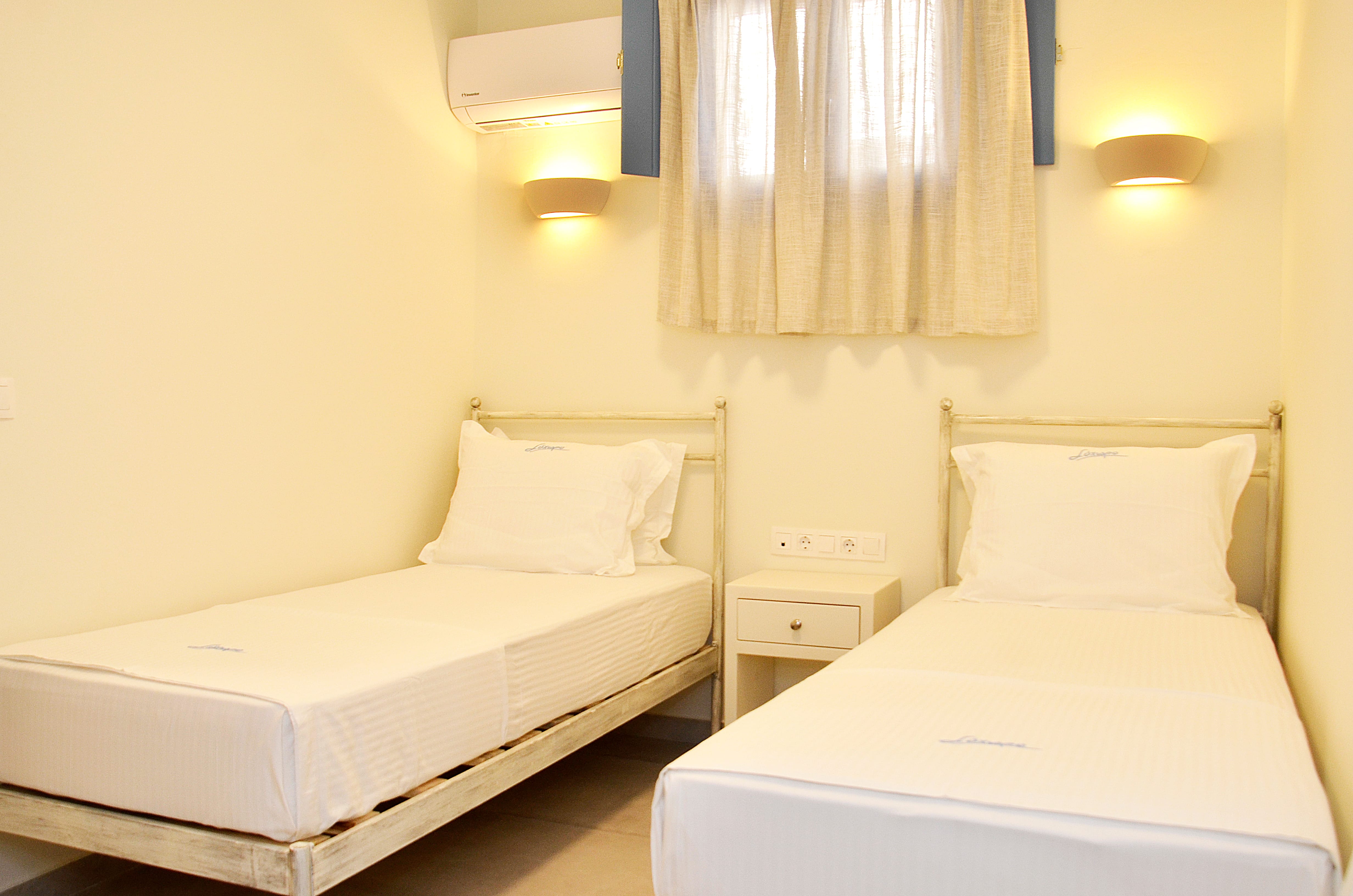 a room with white beds