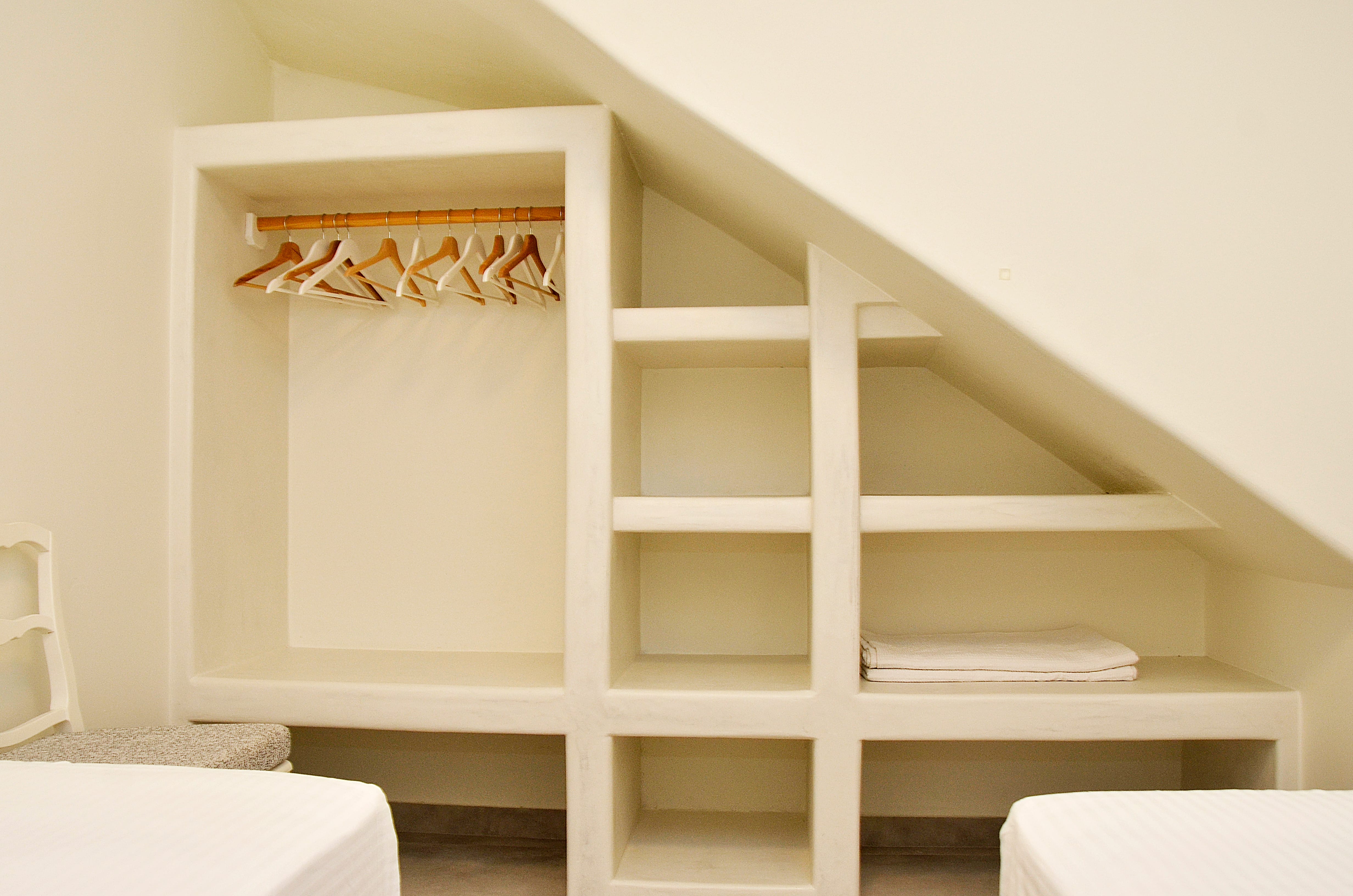a white shelf with a door