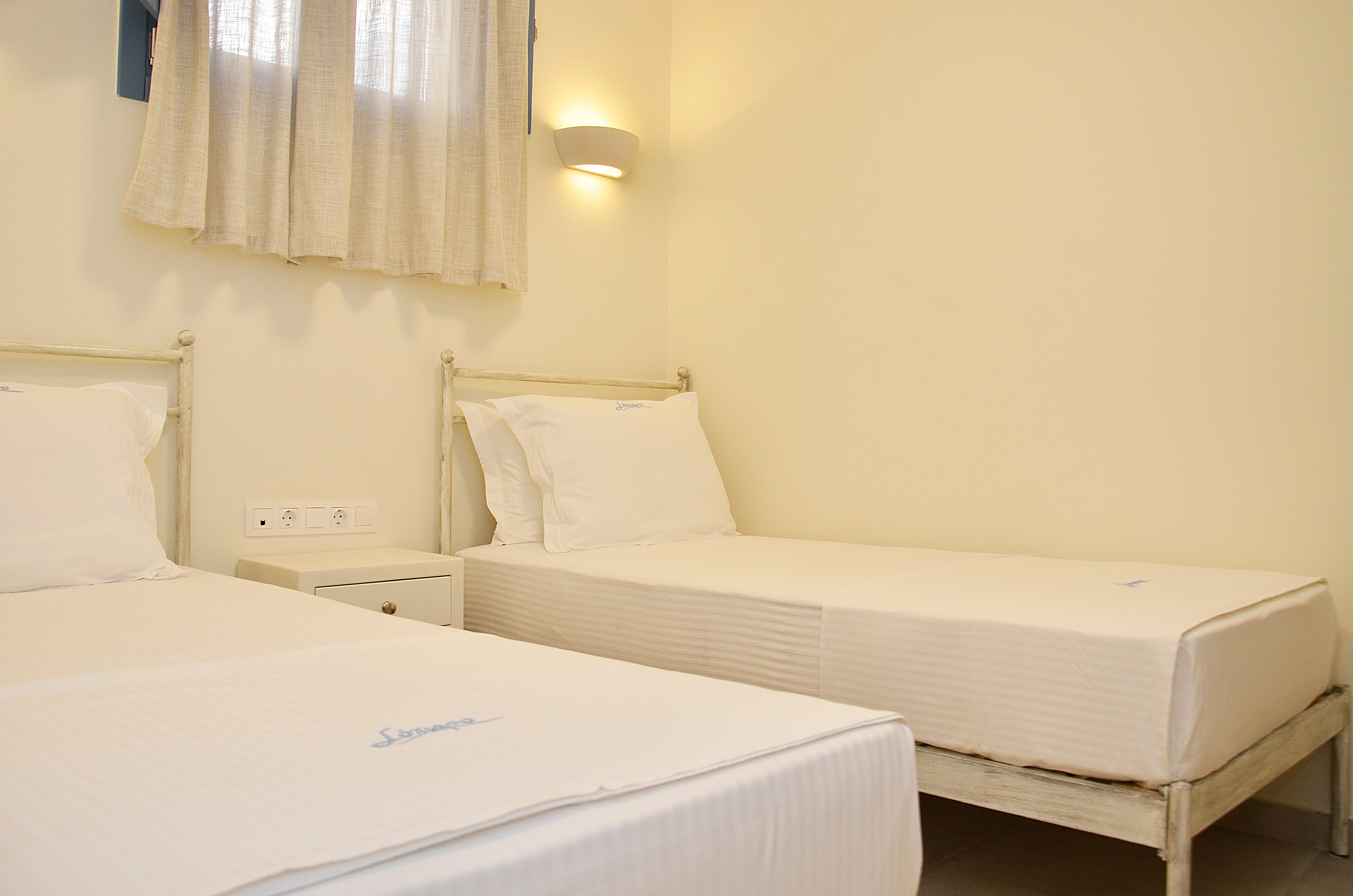 a couple beds in a room