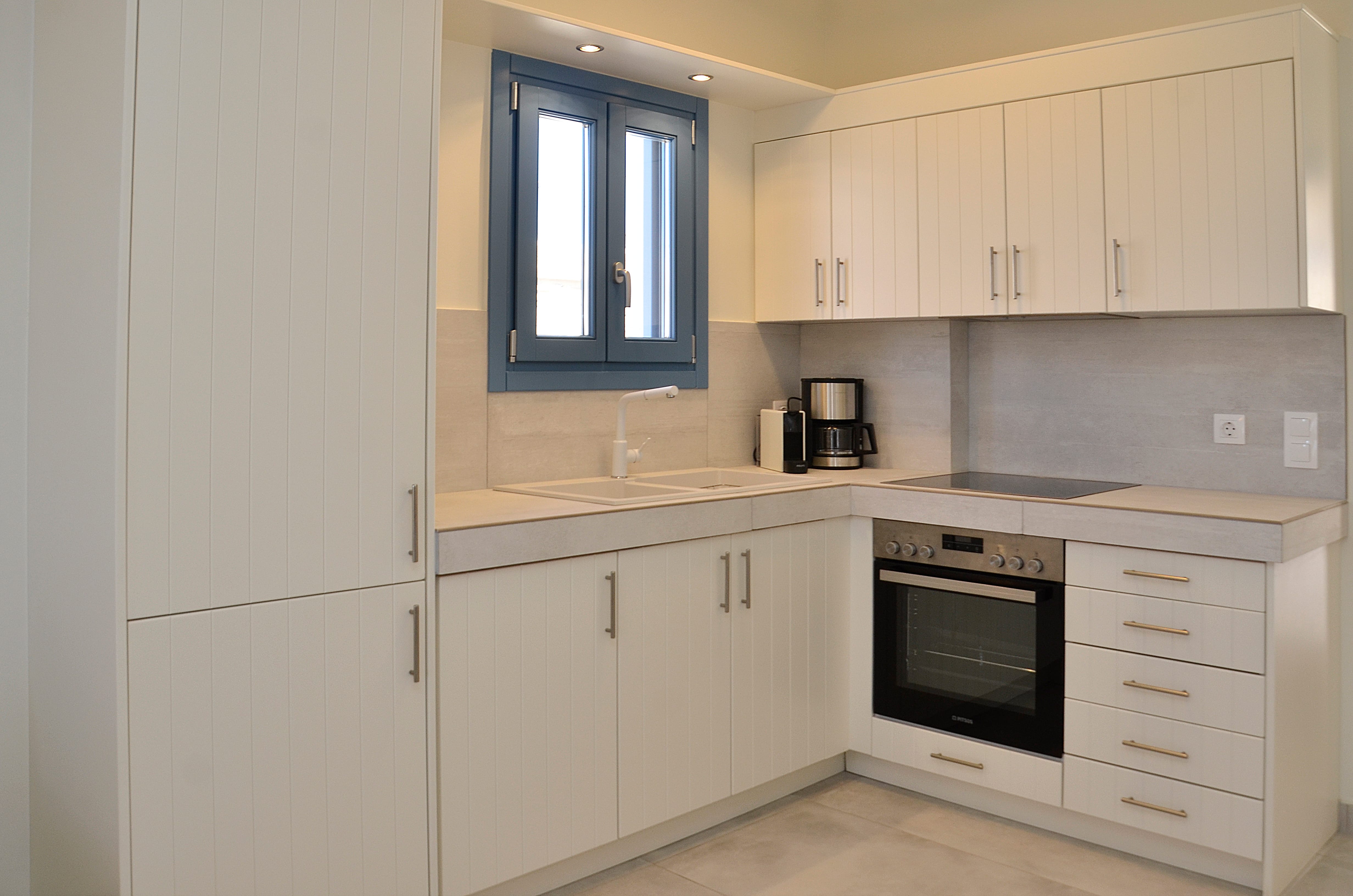 a kitchen with white cabinets