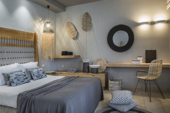 a bedroom with a bed desk and a chair