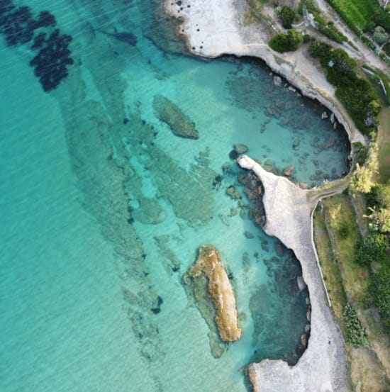 a body of water with rocks and a rock in it