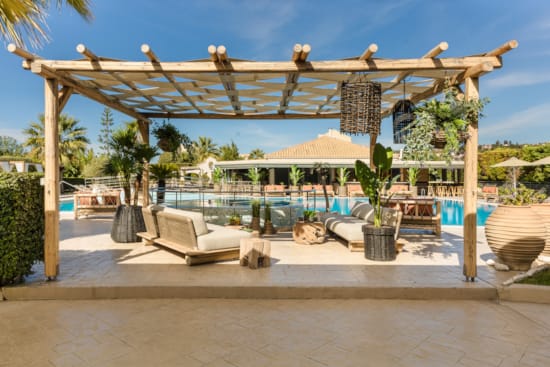 a gazebo with a pool and trees