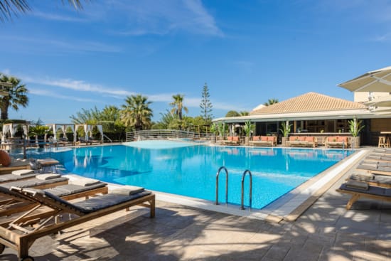 a swimming pool with a building in the background