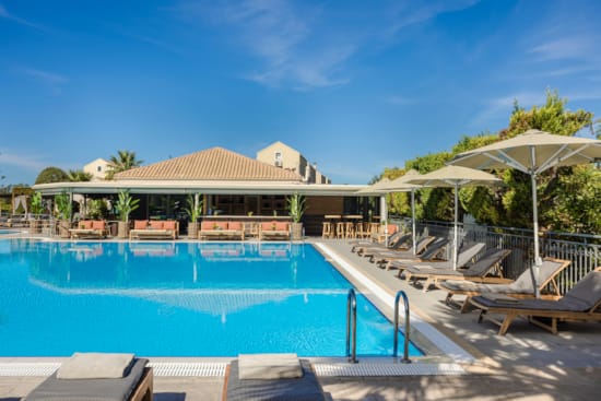 a swimming pool with a building in the background