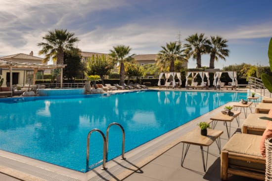 a pool with chairs around it