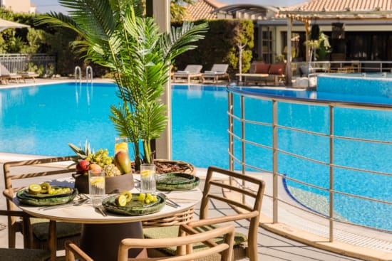 a table with food and drinks by a pool