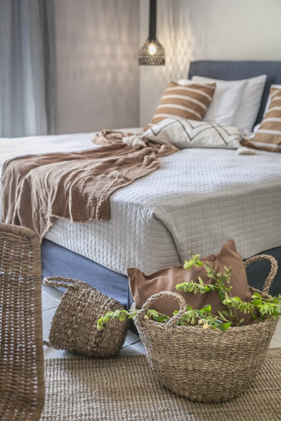 a bed with a basket and a basket of flowers