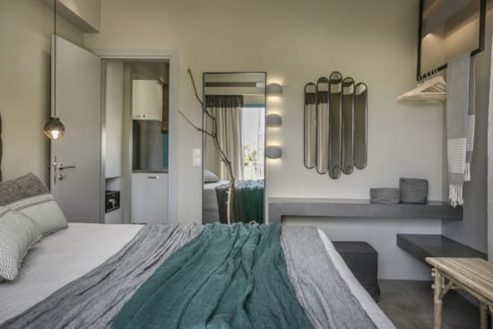 a bedroom with a bed and a mirror