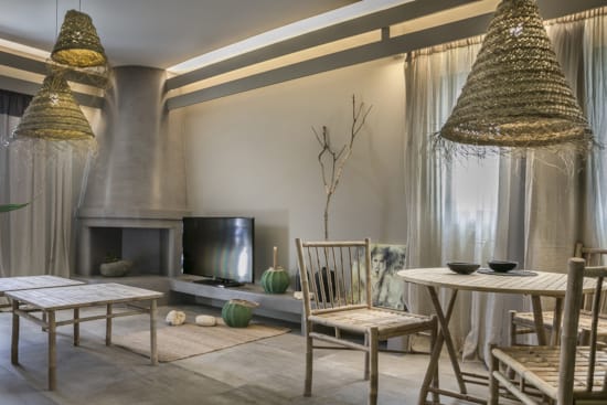 a room with a table chairs and a television