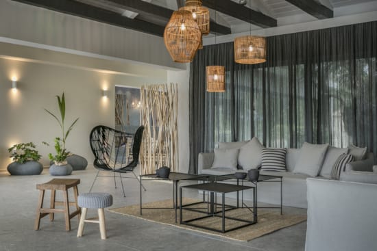 a room with a couch and chairs