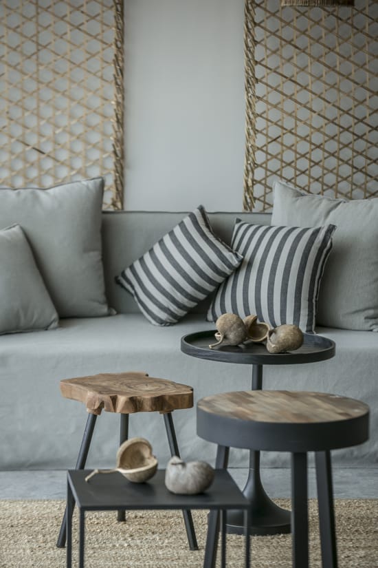 a couch with pillows and a table