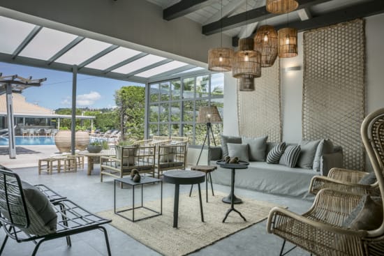 a room with a couch and chairs