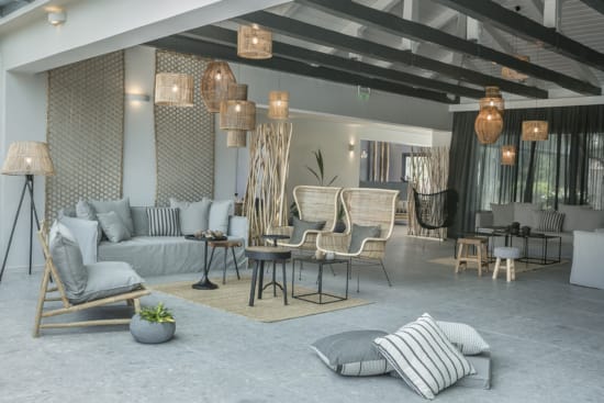 a room with a couch and chairs