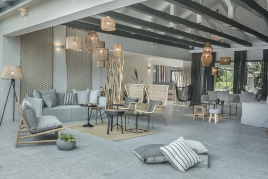 a room with a couch and chairs