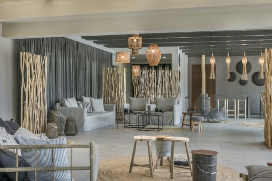 a room with a couch and chairs